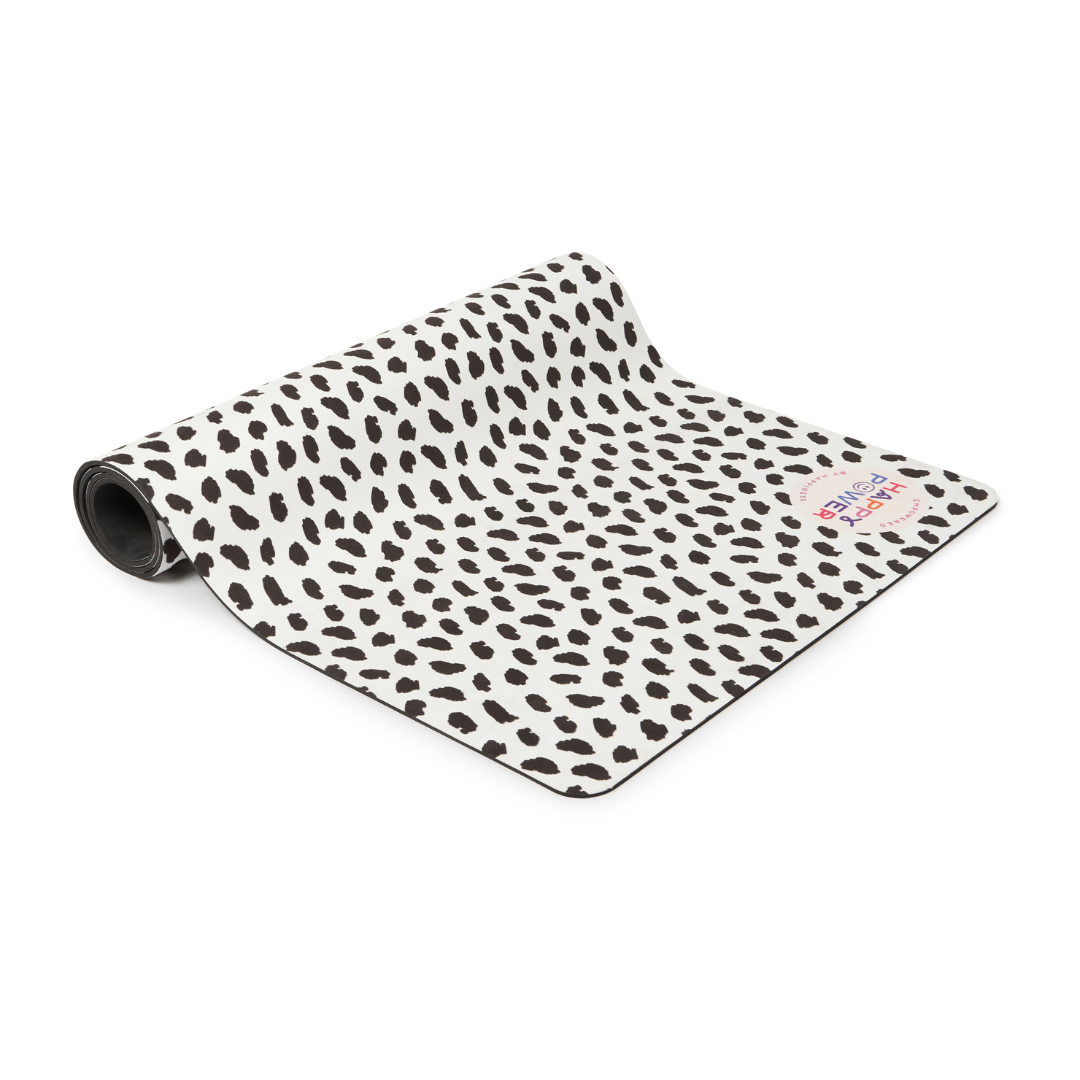 Eco friendly exercise and yoga mat with vegan suede top and natural rubber base featuring Black feather dots on a white background with a dusty-toned rainbow. This mat that can be used for workouts, yoga, pilates, stretching, meditation and more