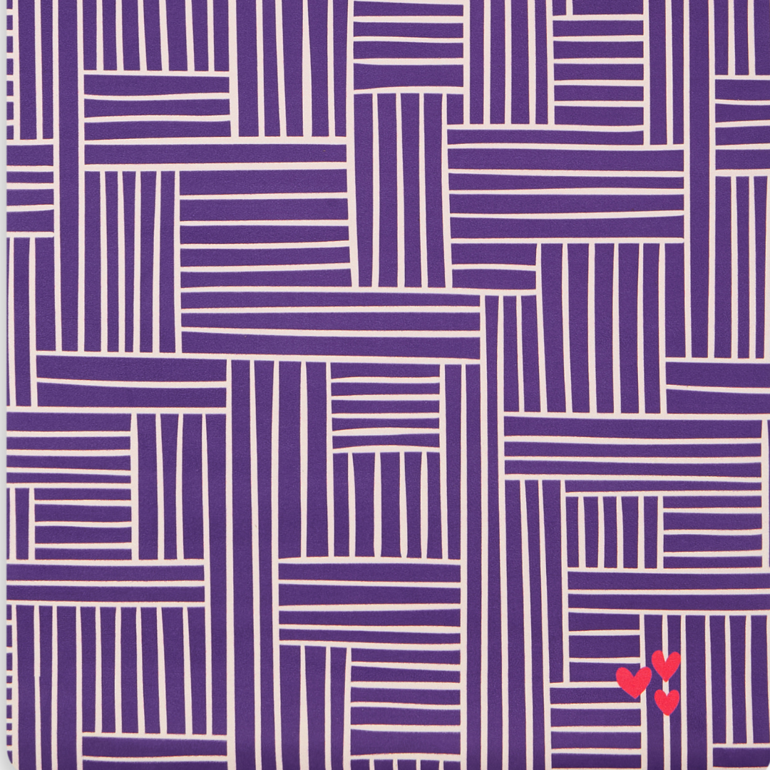 Close up pattern of yoga mat with purple background with white lines and three (3) small hearts on the bottom corner